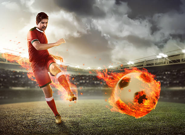 istock Asian football player kick fire ball 537551386