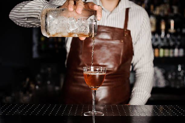 istock barman pouring alcoholic cocktail in glass 537551432