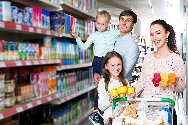 istock Parents with two kids buying fruit yoghurt 537551736