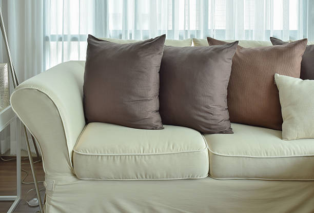 istock Dark brown pillows setting on beige color sofa 537552828
