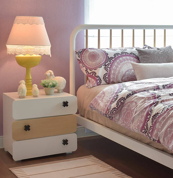 istock Cozy bedroom with pillows and reading lamp on bedside table 537553242