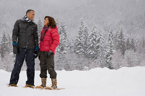 istock Mature woman standing in the snow 537554353