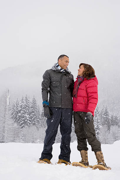 istock Mature woman standing in the snow 537554429