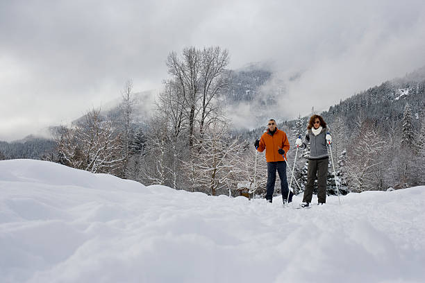 istock Mature couple skiing 537554455