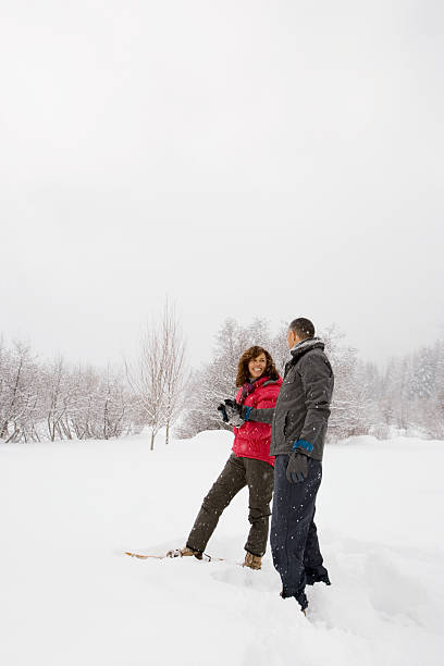 istock Mature couple walking through snow 537554479
