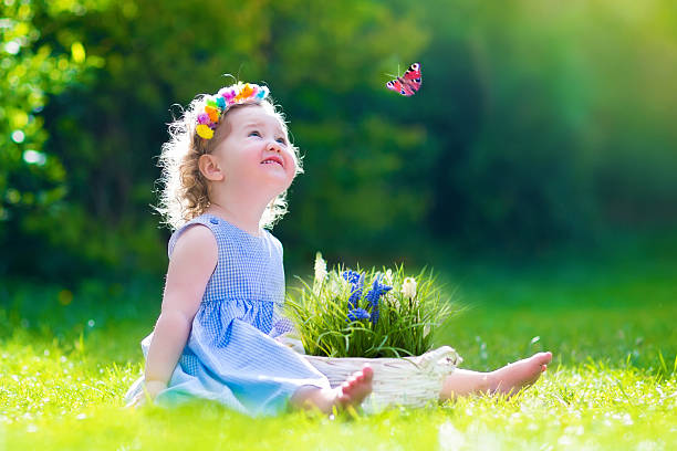 istock Little girl playing with a butterfly 537584931