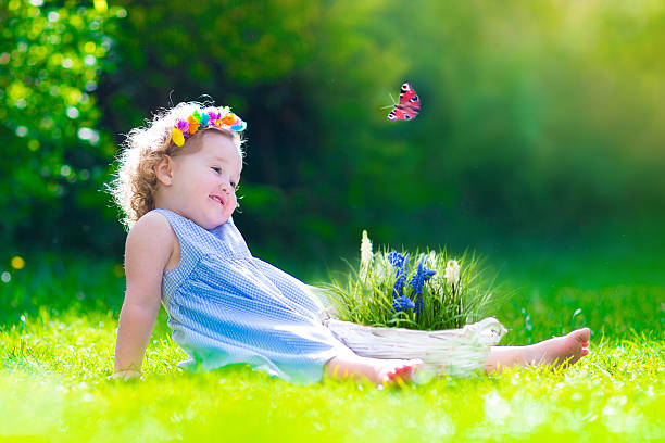 istock Happy little girl playing with a butterfly 537584969