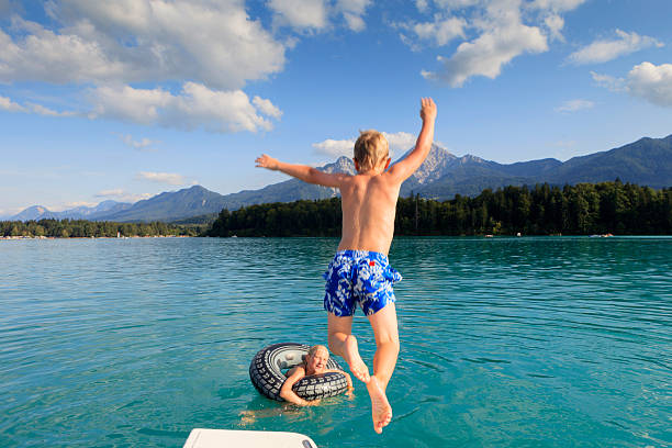 boy and girl swimming in the Faakersee in Carinthia stock photo