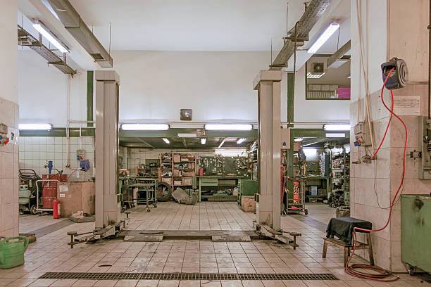 istock Auto Repair Shop Interior with Mechanic in Background 537585353