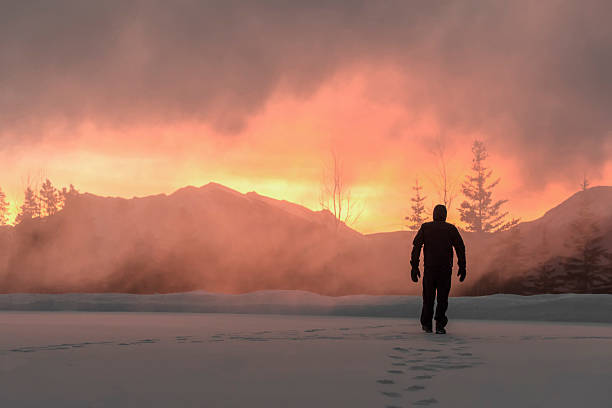 istock Man walks through spindrift snow, sunrise 537586709