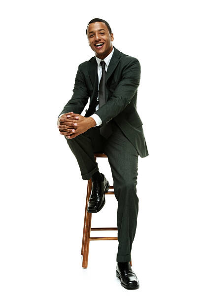 istock Smiling businessman on stool & looking at camera 537594323