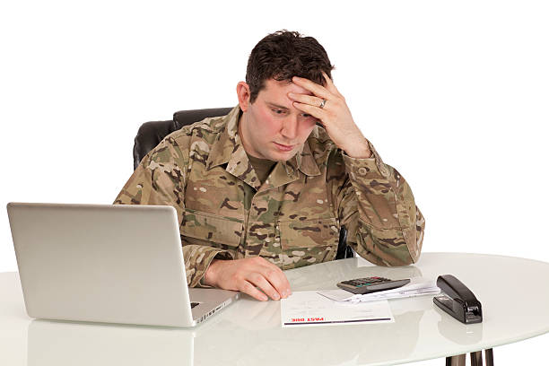 istock Depressed soldier with laptop 537596053