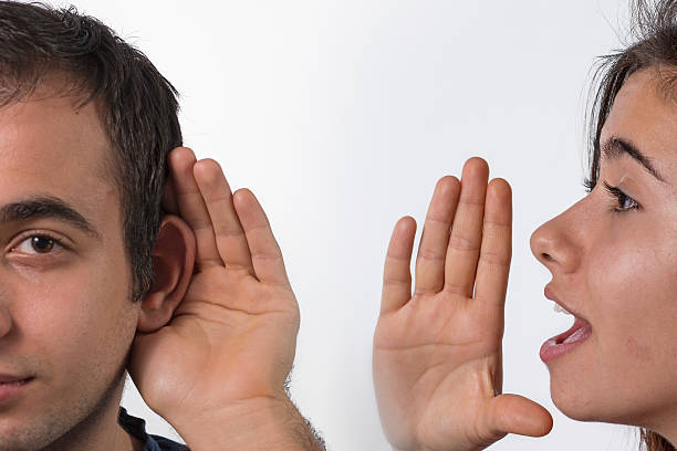 istock Yound girl whispering in man's ear 537598689