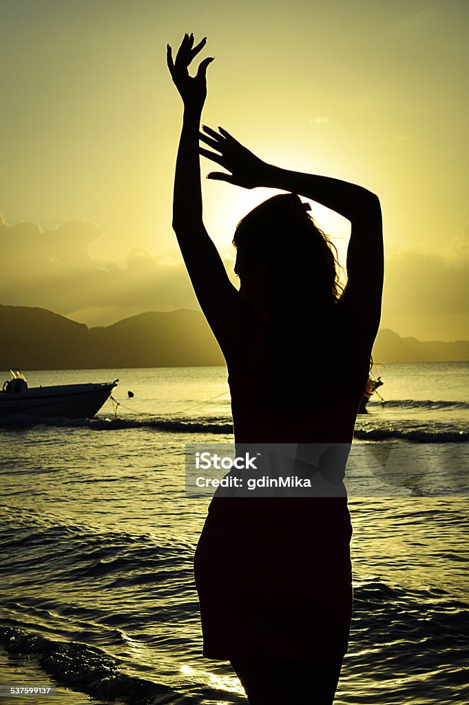 Womans silhouette posing at the beach on Zakyntos & hands Womans silhouette posing at the beach on Zakyntos & hands, nice background, sunrise at the beach in greece, woman dancing on the beach like a fairy, 2015 Stock Photo