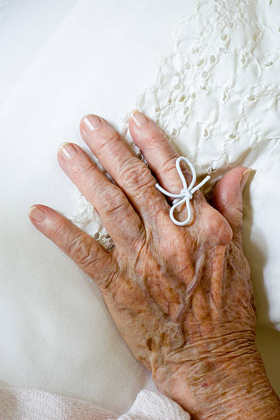 istock String tied on finger of elderly woman 537599979