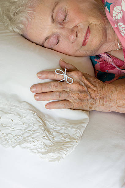 istock Elderly woman sleeping with string on her finger 537600031