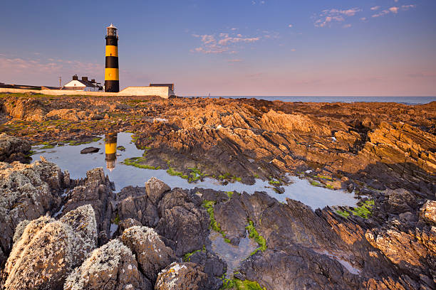 istock Lighthouse in Northern Ireland at sunset 537600758