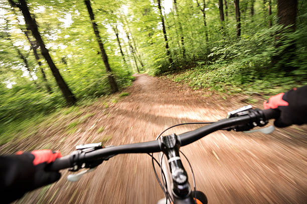 Side view of male mountain biker with blurred background