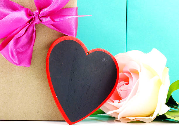 istock heart and roses flower with gift box on blue background 537603412