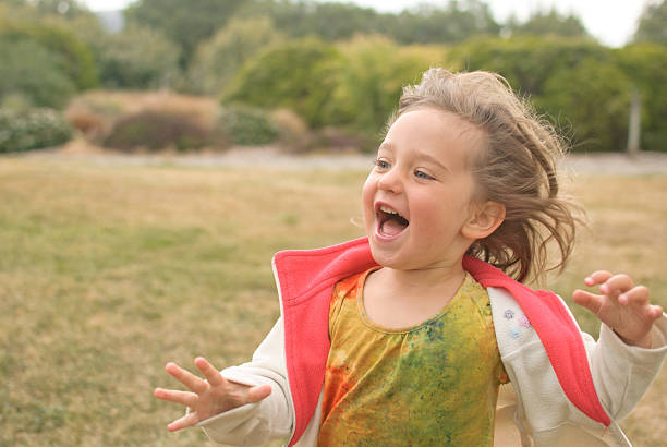 Happy little girl running to playground, Wanaka, New Zealand