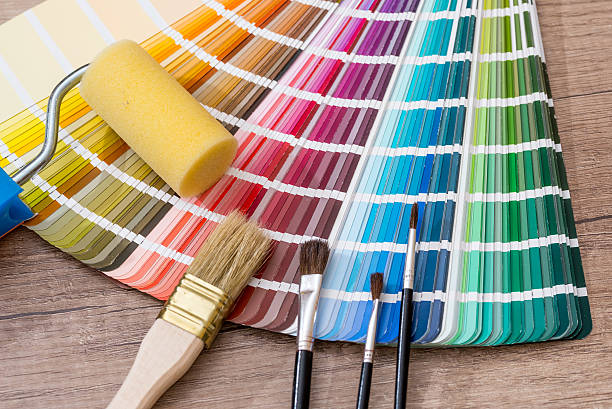 istock Paint roller, brush and color sample catalog on wooden background 537606278