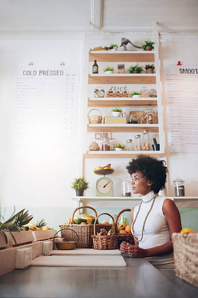 istock Young woman behind juice bar counter 537606496