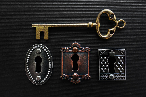Three vintage locks with gold key
