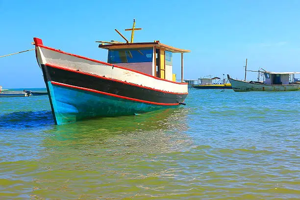 Fishermen rustic wooden boats, Praia do Forte beach, Bahia, Brazil