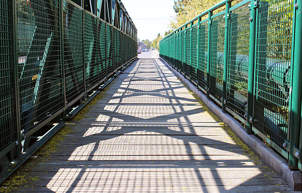 Empty walking road across the green bridge stock photo