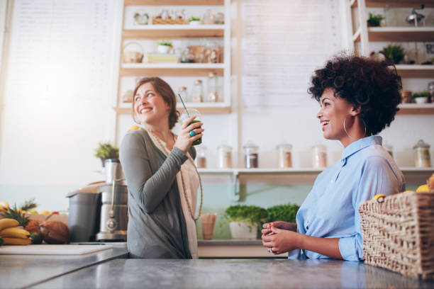 istock Young women working at fruit juice bar 537607516