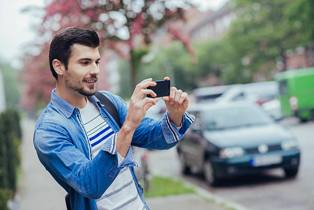 istock handsome man taking a photo with his phone 537609186