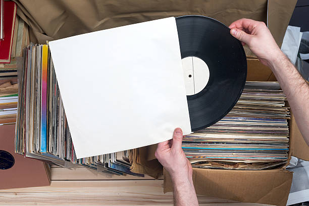 Browsing through vinyl records collection. Music background. Copy space. Retro