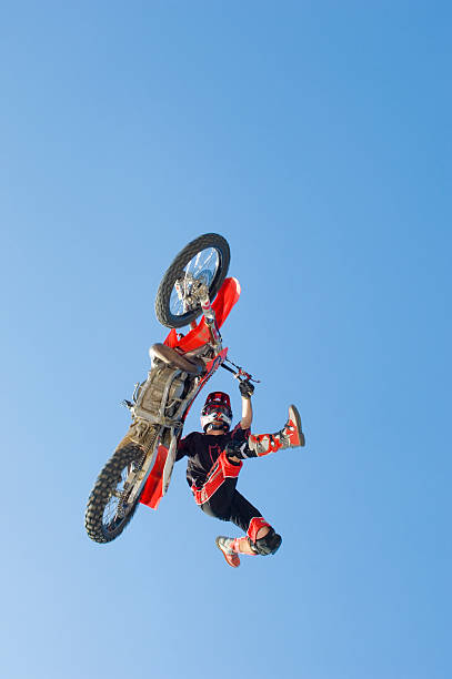 istock Motocross Racer Performing Stunt In Midair Against Blue Sky 537612049