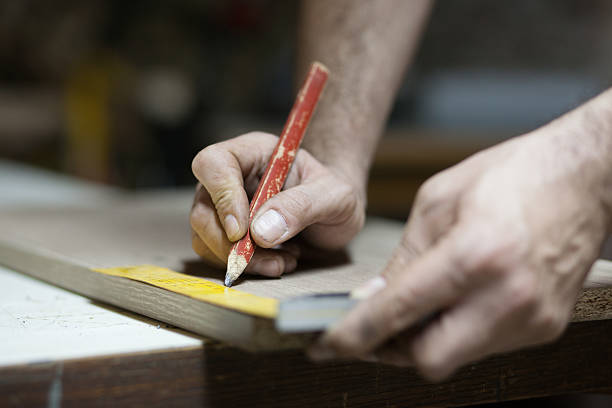 istock Carpenter using theiInstrument of Measurement and drawing with p 537612538