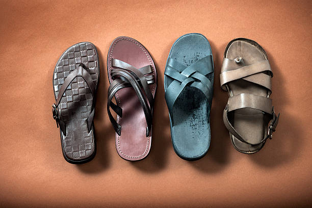 istock Four different kind of flip-flops on brown background 537613003