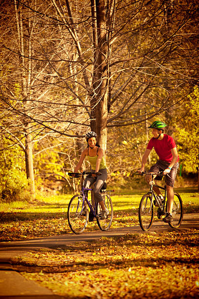 istock Autumn Bicyclists Exercising in Park Bicycle Path 537613190