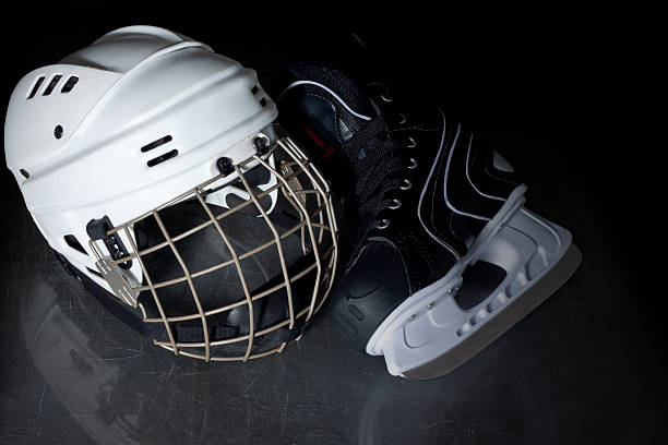 istock ice hockey helmet and skate on ice 537614229