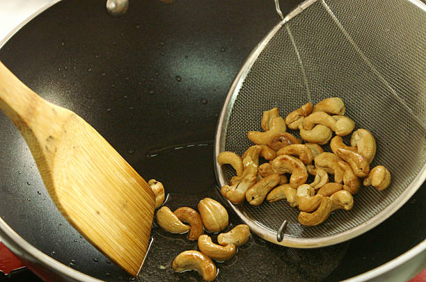 cashew nut fried cryspy in pan stock photo