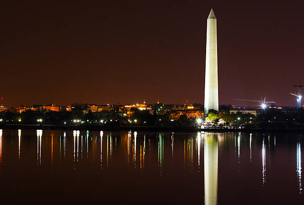 istock Washington Monument at night with the city skyline on background. 537615635