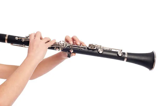 hands playing clarinet on a white background