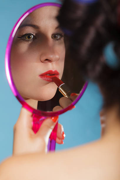 istock Girl applying make up red lipstick 537616713