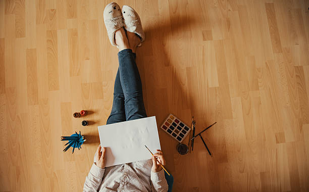 istock Creative workspace: girl hand drawing at home, on the floor. 537616816