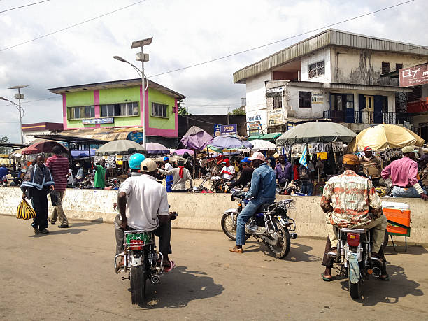 Douala, Cameroon Douala, Cameroon - November 5, 2013: Unidentified people on thje street of Douala, Cameroon. With more than 3 million inhabitants it is a largest city in Cameroon and its commercial capital cameroon stock pictures, royalty-free photos & images