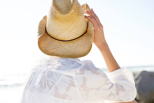 istock Young woman in hat looking at the sea 537618502