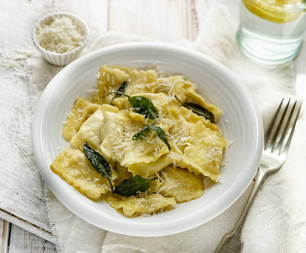 istock Ravioli with sage butter sprinkled with grana padano cheese 537618510