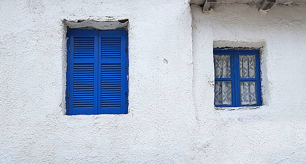 Blue window on old white house in Greece stock photo