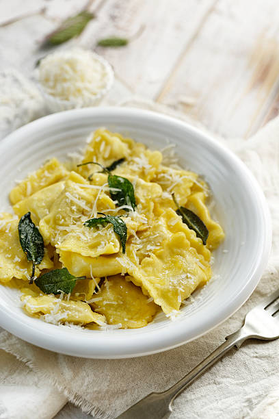 istock Ravioli with sage butter sprinkled with grana padano cheese 537619738