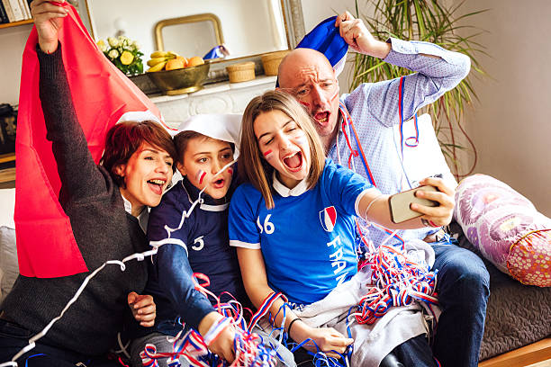 istock french family posing for fan selfie 537620358