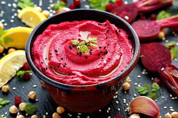 Beet hummus in a ceramic bowl