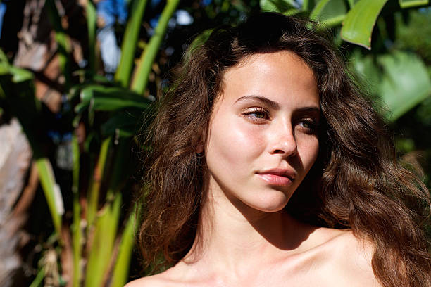 istock Beautiful woman outdoors with bare shoulders looking away 537620660